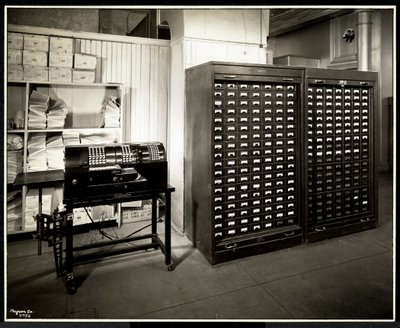 Possibly an adding machine and a filing cabinet with small drawers in the office of the Carolyn Laundry at 111 East 128th Street, East Harlem, New York, 1929 by Byron Company